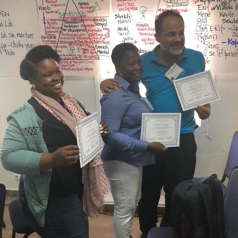 Community leaders holding training certificates